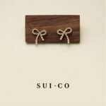 Clio Bow Stud Earrings: Pearl and Zircon Elegance