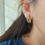 Model wearing Nerelle twisted coil non pierced clip on earrings
