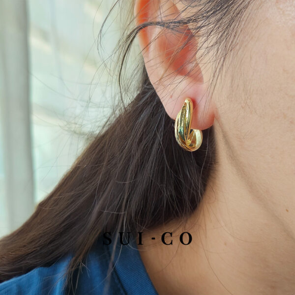 Model wearing Nerelle twisted coil non pierced clip on earrings