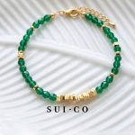 Close up of 4mm faceted emerald czech glass beads with gold plated copper discs sui-co.my