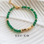 Close up of 4mm faceted emerald czech glass beads with gold plated copper discs sui-co.my